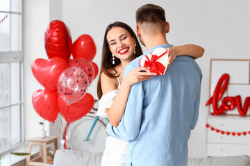 Beautiful young couple celebrating Valentine's Day at home