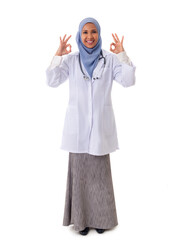 medicine, healthcare, charity and people concept - full size portrait of smiling muslim female doctor wearing white coat and showing ok sign with two arms, isolated over white background