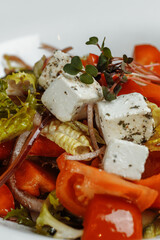 Greek salad with fresh vegetables, feta cheese and black olives