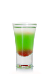 Green alcoholic shot glass with absent, irish cream, liquor