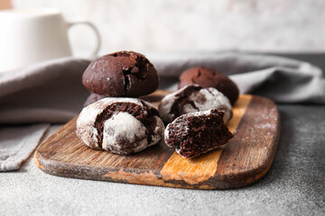 Wooden board of chocolate brownie cookies on table