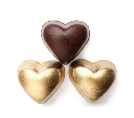 Tasty heart-shaped candies on white background