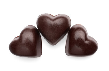 Tasty heart-shaped candies on white background