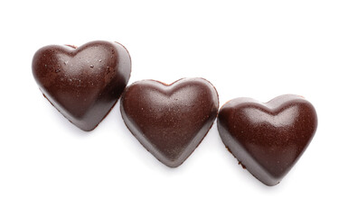Tasty heart-shaped candies on white background
