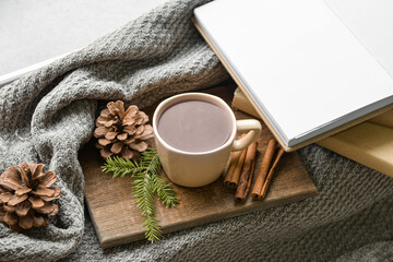 Fototapeta na wymiar Cup of tea, fir branch and blank book on windowsill