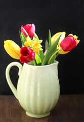 spring flowers in a vase, tulips, daffodils