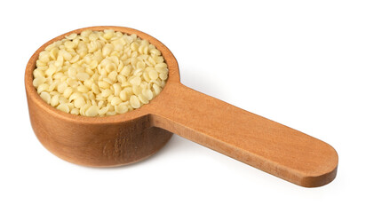 Hulled hemp seeds in the wooden spoon, isolated on the white background