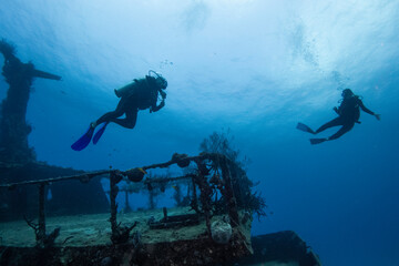 divers enjoying a deep wreck ship