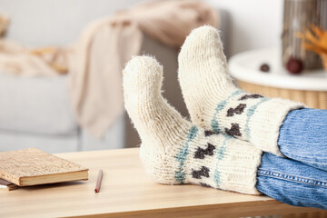 Fototapeta na wymiar Woman in warm socks at home, closeup