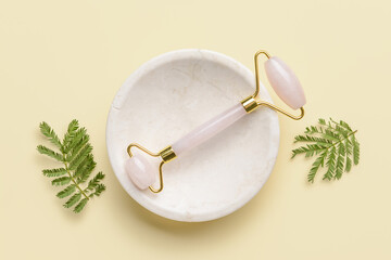 Face massage roller on light background