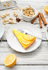 Plate with slice of tasty lemon tart on table
