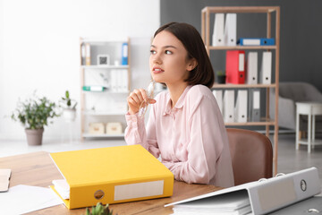 Young woman working with documents in office