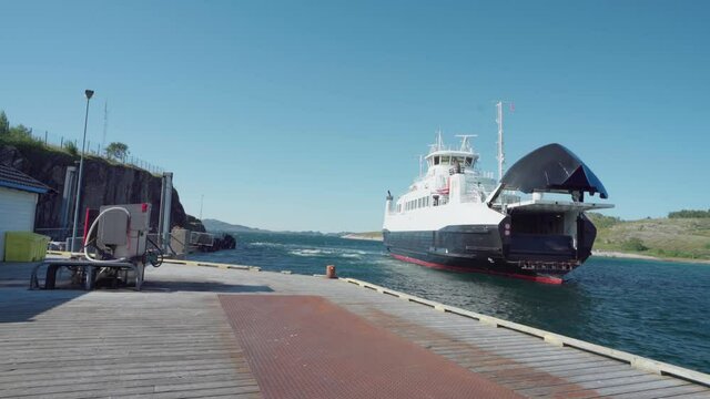 Passenger Boat Sailing Near The Dock At The Harbour Of Lovund Island, Norway. wide shot