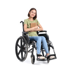 Obraz na płótnie Canvas Young woman in wheelchair and with notebook on white background