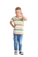 Adorable little boy in striped t-shirt showing victory gesture on white background