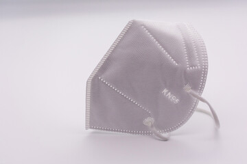One KN-95 protection medical mask isolated on white background. Prevention of the spread of virus...