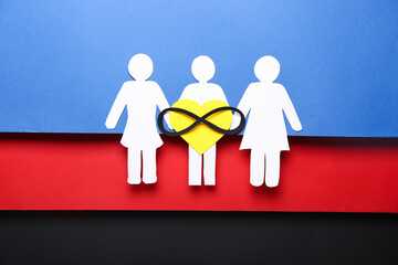 Paper human figures on polyamory flag