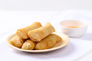 Asian deep fried spring roll filling with tofu, cabbage, carrot and glass noodle on natural plate...