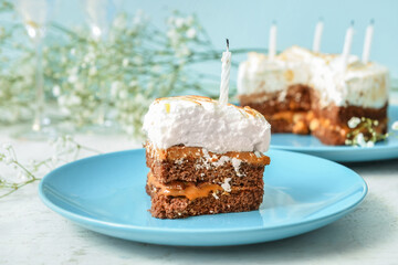 Plate with piece of tasty birthday cake on table, closeup