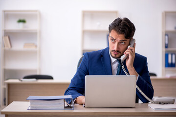 Young male employee working in the office