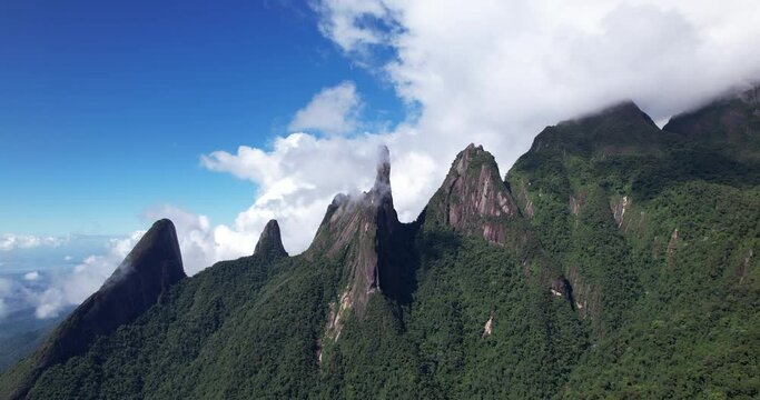 Ascending aerial panorama landscape of Brazil mountain range Serra dos Orgaos in Teresopolis near Rio de Janeiro with jurassic looking rock peaks and steep flanks