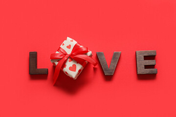 Gift for Valentine day and word LOVE on red background
