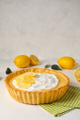 Delicious lemon tart on light background
