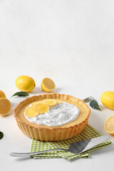 Delicious lemon tart on light background