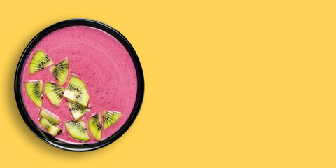  Smoothie bowl on yellow background. Top view. Copy space