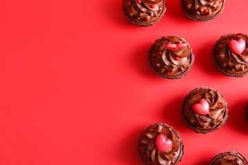 Tasty chocolate cupcakes for Valentine's day on red background