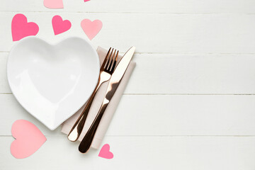 Stylish table setting for Valentine's Day on white wooden background