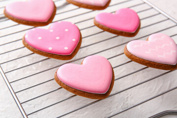 Grid with tasty heart shaped cookies on white background, closeup