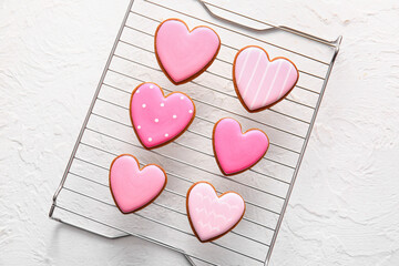 Grid with tasty heart shaped cookies on white background