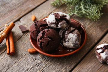 Plate of chocolate brownie cookies on wooden background