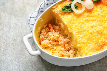 Baking dish with tasty English fish pie, closeup