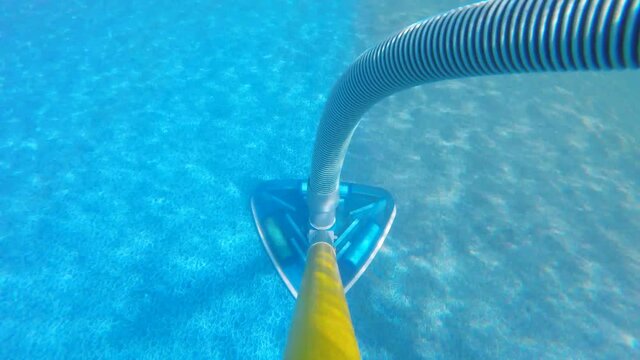 Time lapse of cleaning dirty pool with vacuum underwater on pole shot