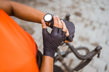 cyclist check his workout progress on a smart watch