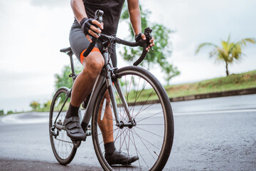 male cyclist with hand on a handle bar close up