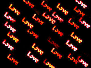 Love text writting in white red yellow word bokeh romance isolated on black background. Valentine's day14th February holyday, anniversary or wedding greeting card, invitation, wallpaper. Soft focus