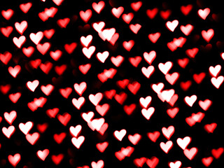 Fototapeta na wymiar Valentine's day red hearts bokeh in heart shape love romance isolated on black background with copy space, 14th February holyday, birthday, anniversary or wedding backdrop, greeting card, invitation