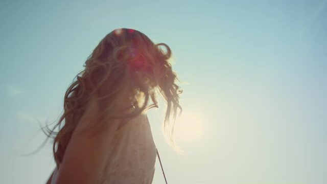 Closeup happy woman in love dancing in light outdoors. Smiling woman in sunshine