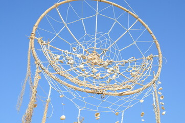 Dream catcher against blue sky. 