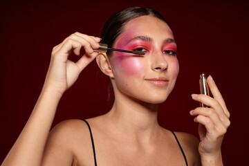 Portrait of beautiful young woman pink face makeup posing attractive look skin care cropped view unaltered