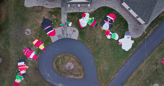 Blow up lawn inflatables for Christmas. Top down aerial of deflated snowman after holiday season.