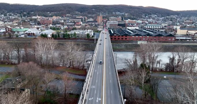 Bridge over Lehigh River in Bethlehem Pennsylvania during winter. Slow motion clip of traffic driving. Aerial.