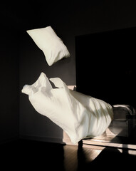 Blanket and pillow floating in air; levitating abstract