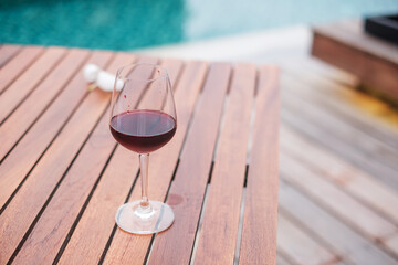 Red wines glasses near swimming pool. Summer travel, vacation, holiday and happy weekend concept