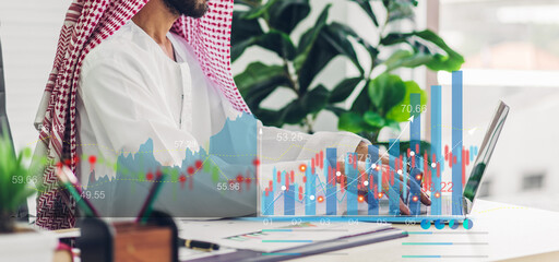 Portrait of arabic success arab businessman using technology of laptop looking at progress of business financial investment data graph and chart business growth increase at office