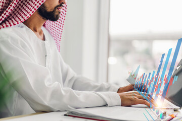 Portrait of arabic success arab businessman using technology of laptop looking at progress of...