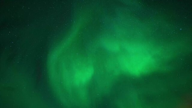 Magical Aurora Borealis Dancing At The Night Sky With Stars. - low angle